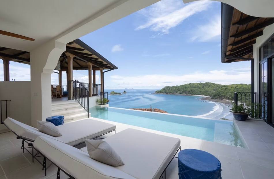 Infinity pool and daybed overlooking the ocean