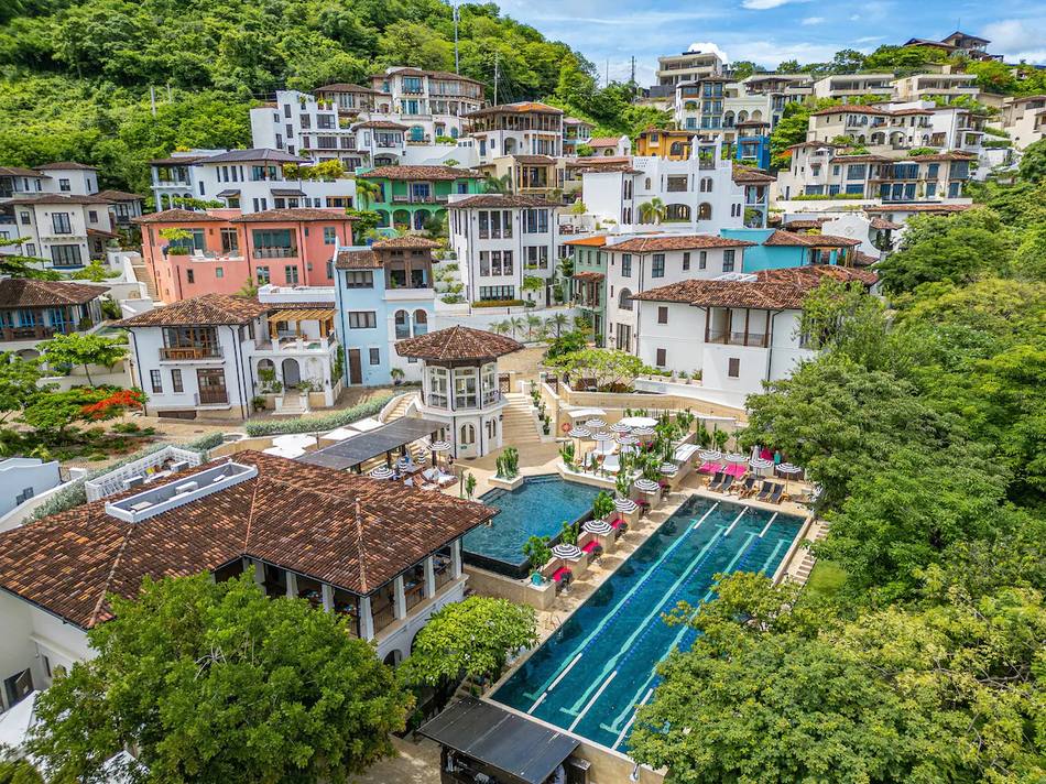 Colorful hillside town and pools at Las Catalinas