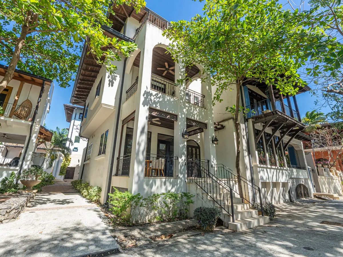 Paseo Del Mar Villa, a white three-story home under shade trees